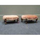 A pair of Victorian footstools with upholstered tops on cabriole legs