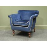 A country house Victorian armchair with navy upholstery, the feather filled seat cushion on turned