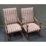 A pair of oak elbow chairs in the 17th century style, upholstered in modern rectangular panel