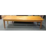A large 20th century blonde oak tailors table, the five plank top above four square tapering legs 75