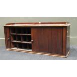 A late Victorian or Edwardian desk top cabinet fitted with pigeon holes, enclosed by a tambour