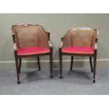 A near pair of Edwardian crossbanded mahogany bergere armchairs (2)