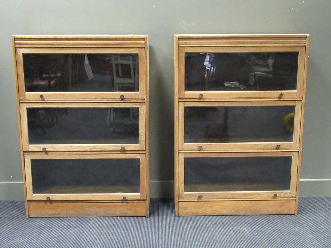A pair of oak Globe Wernike style bookcases each with three compartments 129 x 88 x 34cm