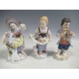 A group of Meissen porcelain figures to include a figure of girl holding flowers in a her apron, a