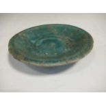 A Kashan pottery green glazed dish, 15cm diameter