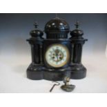 A black slate mantle clock, the central finial in the form of a classical bust