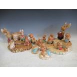 A large collection of Pendelphin rabbits together with two Pendelphin stands