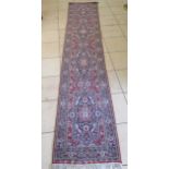 A hand knotted North West Persian runner 394 x 76cm