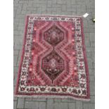 A Kazak type rug, with three ivory lozenges, on a blue and dark red ground, 160 x 120 cm approx;