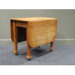 A 1920’s oak drop leaf table and four bar and lathe back dining chairs