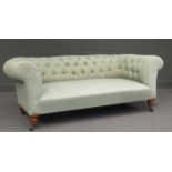 A late Victorian or Edwardian button upholstered Chesterfield with turned front legs 186cm wide
