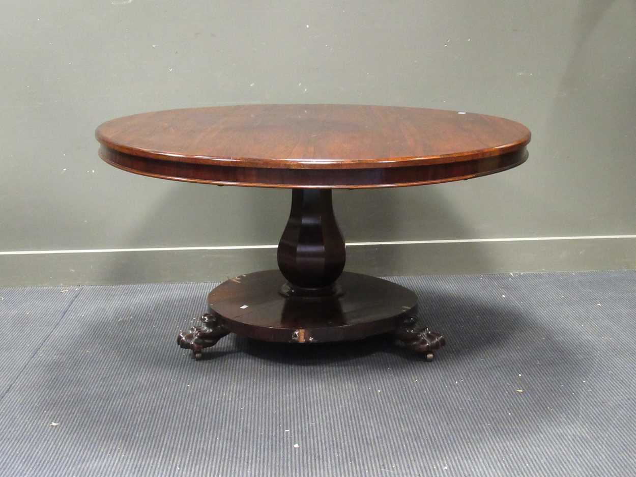 A William IV rose wood breakfast table on platform base with paw feet. 70 x 135cm