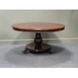 A William IV rose wood breakfast table on platform base with paw feet. 70 x 135cm