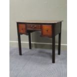 An 18th century oak and fruitwood three drawer lowboy the pinched corner top over reeded square legs