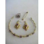 A collection of jewellery including a stock pin tested as 9ct gold, a pair of gemset ear pendants