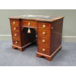 An Edwardian mahogany and crossbanded kneehole desk, breakfront outline, leather inset top, 99cm