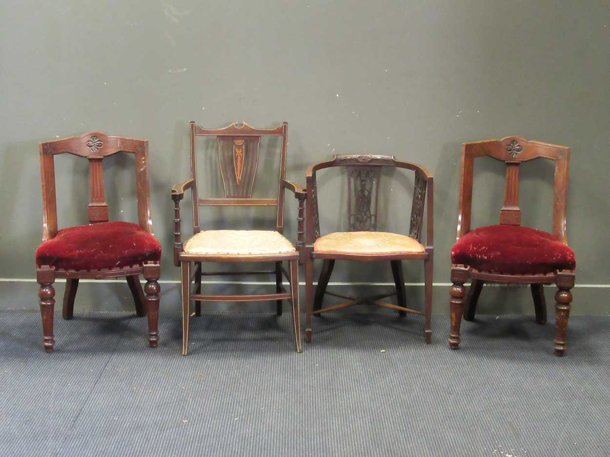 An Edwardian mahogany and inlaid armchair together with another Edwardian armchair and two late
