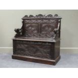 A late Victorian carved oak box seat settle 107 x 108 x 46cm