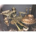 A large collection of copper and brassware, to include kettles, jam pan, trivets, moulds,