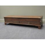 A low narrow oak coffer with hinged top and two drawers below, 144cms