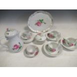 A modern Meissen coffee pot, a matching tray, three cups and saucers, a sugar bowl and cover and