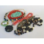 A collection of bead jewellery and two medallions