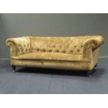 A Chesterfield sofa, on turned legs with brass castors, 195cm wide