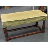 A rectangular mahogany footstool, with green upholstery on four reeded legs and stretchers 49 x