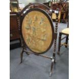 A George III style mirror and a fire screen with tapestry oval panel