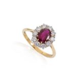 A ruby and diamond cluster ring set in 18ct gold,