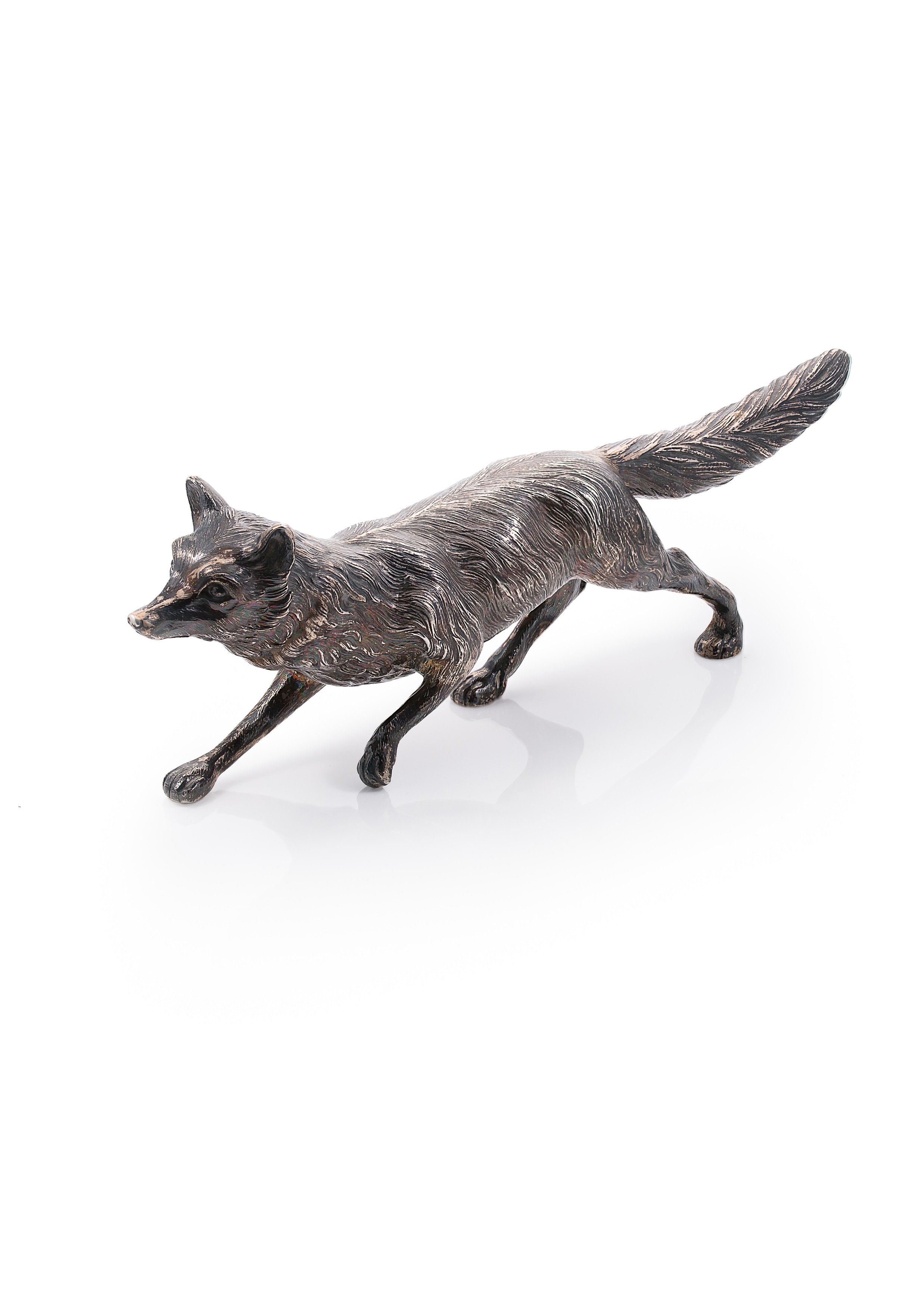 An early 20th century German metalwares silver table decoration in the form of a running fox,