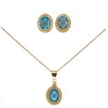 A blue topaz pendant and chain together with a pair of matching ear studs,
