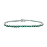 An emerald line bracelet set in 18ct white gold,