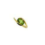 An 18ct gold crossover style peridot ring,