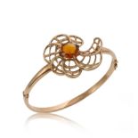 A late 20th century 9ct gold hinged bangle set with a citrine,