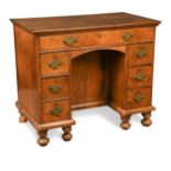 A walnut kneehole desk, 18th century and later,