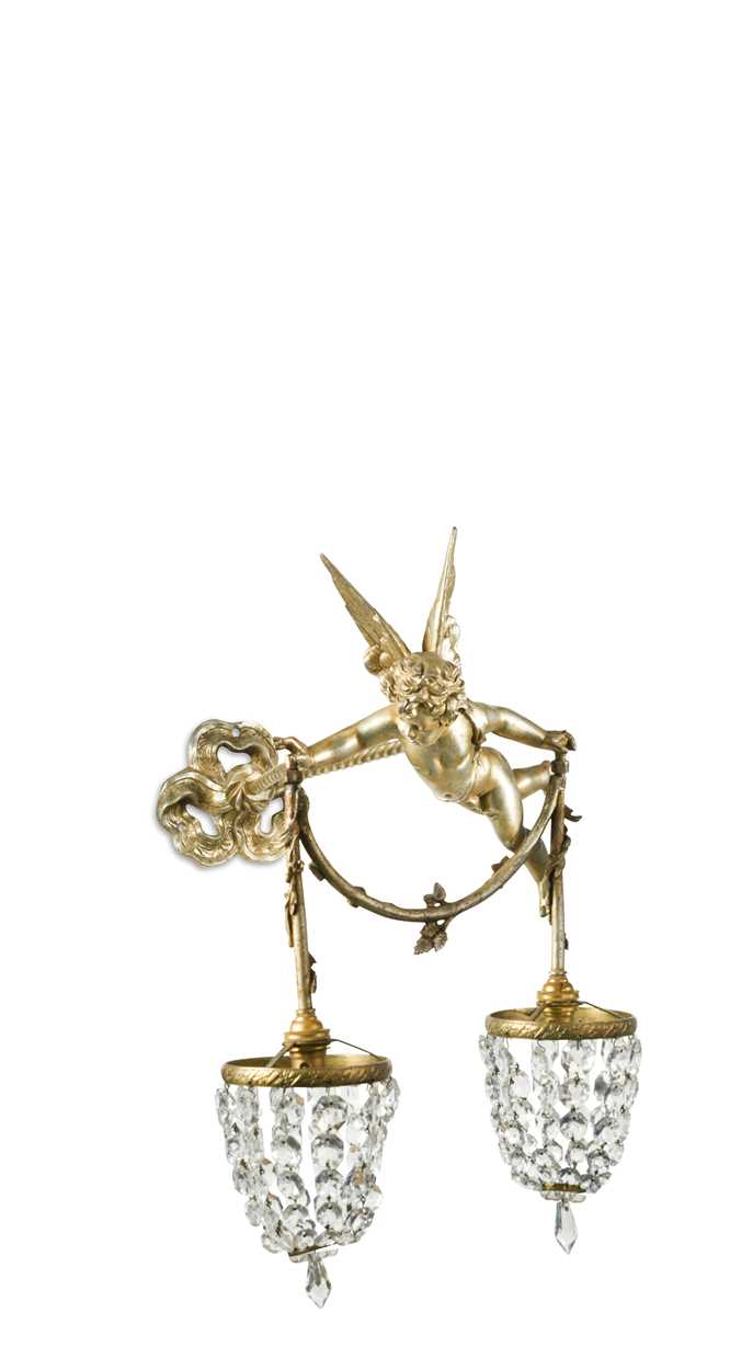 A gilt-metal wall light as a winged cherub holding a pair of bag chandeliers,