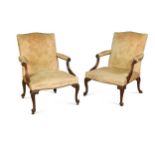 A pair of early George III mahogany library open armchairs,
