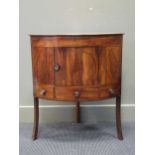 A George III mahogany corner washstand, fitted with a cupboard above a drawer and two dummy drawers,