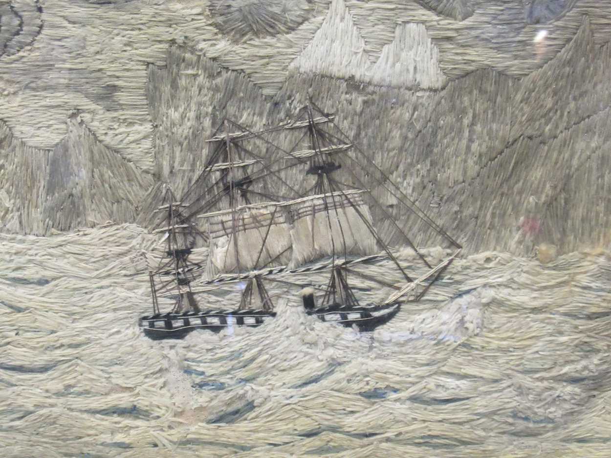 A maple-framed 19th century sailor's woolwork depicting a steamship sailing close to an iceberg in a
