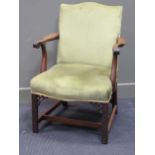 A George III style elbow chair with serpentine back and seat on carved legs with fret carved