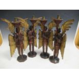 A set of four carved and gilt candlesticks modelled as angels, 40cm high (4)