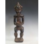 A carved tribal figure of a man, 53cm high