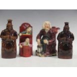 Two treacle glazed spirit flasks modelled as 'Old Tom'; a Staffordshire figure of 'The judge and the