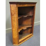 A 19th century walnut splay front hanging corner cabinet, the open front with two shaped shelves