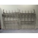 A pair of Gothic style wrought metal garden gates and a single gate, the gates 190 tall x 146cm wide