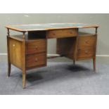 A 20th century curved writing desk with green canvas leather top comprising of two shelves and