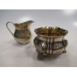 A silver three footed sugar bowl and an Edwardian cream jug by Mappin and Webb
