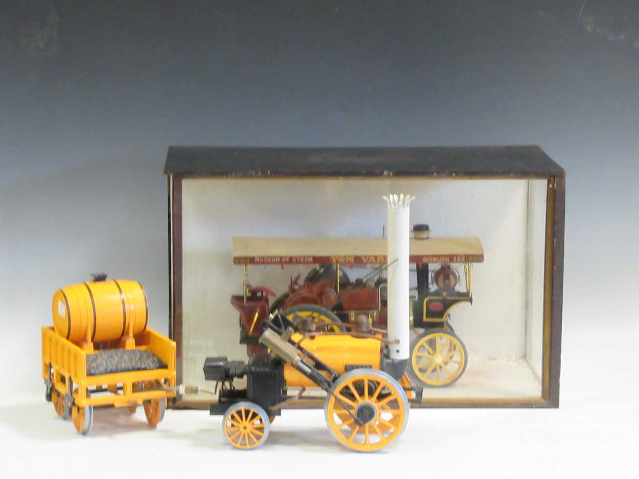 A miniature steam engine in a glazed wooden case and a Hornby model of The Rocket (2)