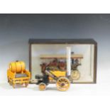 A miniature steam engine in a glazed wooden case and a Hornby model of The Rocket (2)
